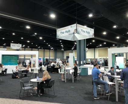 Exhibit hall B with full lighting with LED lights and tradeshow with large vehicles