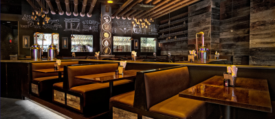 Photo of the interior of Copper blues restaurant with bar and tables set